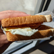 hand holding breakfast sandwich